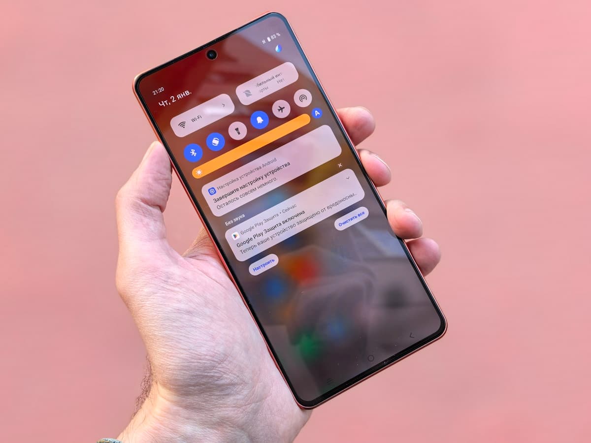 Hand holding a smartphone with push notifications visible on the screen
